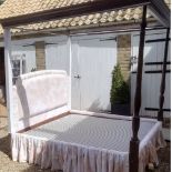 A Hepplewhite style mahogany four poster bed, with turned circular front posts in the classical