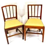 Four Sheraton style elm kitchen chairs, each with vertical splats on square tapering front