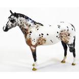 A 20thC Beswick standing Appaloosa horse, printed marks beneath, 20cm high.