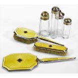 A chrome plated and yellow enamel dressing table set, to include hand mirror 31cm wide, clothes