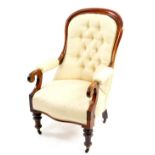 A Victorian mahogany show frame armchair, overstuffed to the button back, arms and seat, on turned