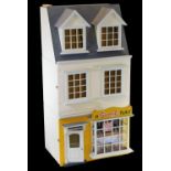 An Anglesey doll's house sweet shop, with articulated front, with shop interior to the lower