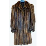 A ladies fur coat, three quarter length.