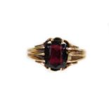 A 9ct gold garnet dress ring, with textured part pierced shank, size S, 4.4g all in.