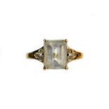 A dress ring, claw set with white paste, flanked by three small white stones to each shoulder,