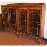 A mahogany bookcase of large proportion, the rectangular body set with a blind fret, above four