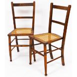 A pair of Edwardian oak and bergere salon chairs, each with horizontal splats on turned front