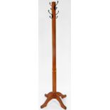 An early 20thC oak Arts and Crafts hat stand, with square block stem and four scroll feet with metal