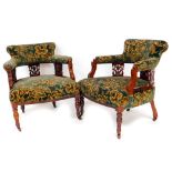 A pair of late 19thC low back chairs, each of C shape with overstuffed backs, arms and seats in