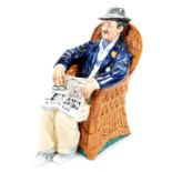 A Royal Doulton figure Taking Things Easy HN2677, printed marks beneath, 18cm high.