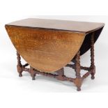 A late 19thC barleytwist table, on heavy turned supports with gate leg action on ball feet, when