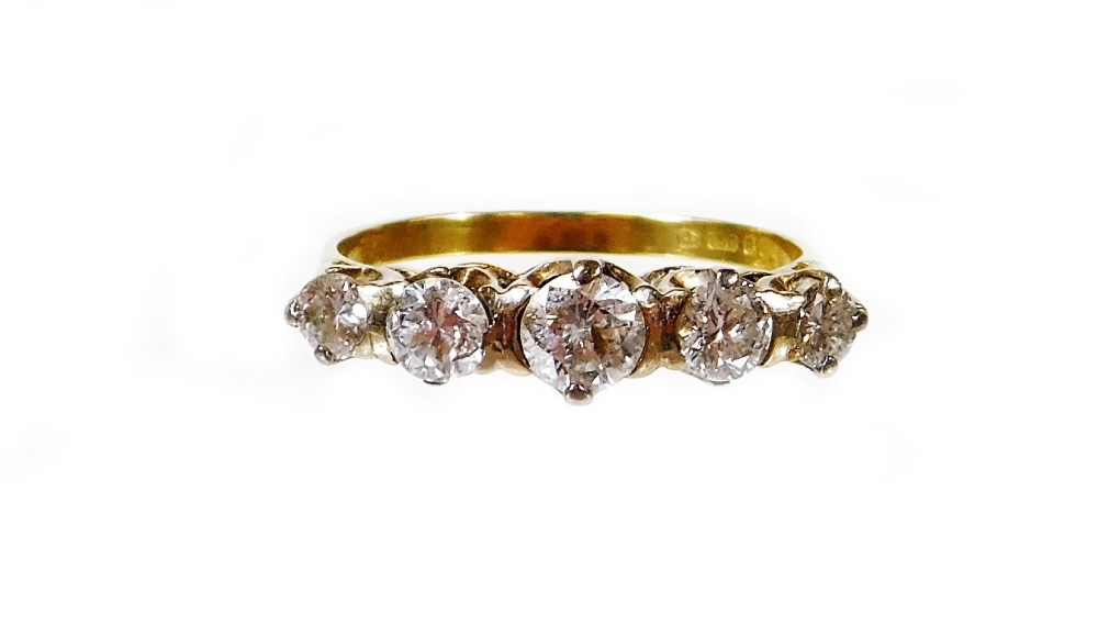 An 18ct gold five stone diamond ring, set with five graduated round brilliant cut diamonds, in a