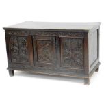 A 19thC carved oak court cupboard base, of rectangular form, the heavily carved front with central