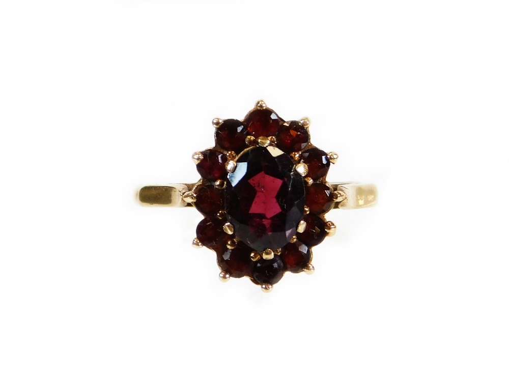 A 9ct gold cluster ring, set with cluster of garnets, of two sizes, ring size N, 3.1g all in, boxed.