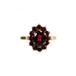 A 9ct gold cluster ring, set with cluster of garnets, of two sizes, ring size N, 3.1g all in, boxed.