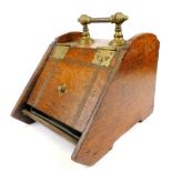 An early 20thC oak coal box, with brass hinges and fixed handle, 39cm high.