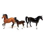A 20thC Beswick matt finish figure of a prancing horse, left leg up, 18cm high and two other horse