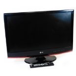 A LG 27 inch HD television, in black with wire and remote control.