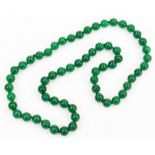 A string of modern jade style beads, on brown string, with single knot divide, each bead 1.5cm wide,