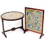 An early 20thC petit point fire screen, of rectangular form on shaped feet, 67cm high, 46cm wide,