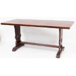 An early 20thC oak refectory table, the rectangular top raised on heavy legs pierced with heart