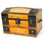 A 20thC dome top trunk, with wooden banding and metal mounts with leather side handles, 49cm high,