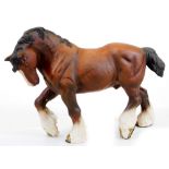 A 20thC Beswick matt finish figure of a large standing shire horse, right leg up, marked beneath,