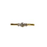 A dress ring, with three illusion set diamonds the plain shank marked 18k, size T, 2.5g all in.