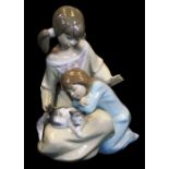 A Lladro figure group of two children and kitten, no. 1354, printed and impressed marks beneath,