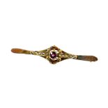 An Edwardian bar brooch, of ellipse form with plain pin back set with an arrangement of small