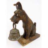 A 20thC carved treen figure, of a dog holding metal bell to the mouth, on plain rectangular base,
