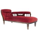 An Edwardian walnut stained chaise lounge, in later part studded burgundy material re upholstered in