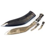 A Kukri with shaped blade, miniature knives and leather scabbard with metal mounts, 41cm wide.
