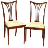 A pair of mahogany and boxwood strung dining chairs, with shaped cresting rails, inverted pierced