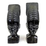 A pair of African tribal heads, with elaborate shaped hair, unmarked, 35cm high.