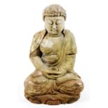 A carved wooden figure of Buddha in seated pose with legs crossed, holding a bowl, traces of painted