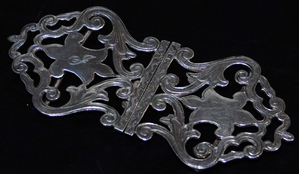 A George V silver two piece buckle, of shaped pierced form with scrolls and central cartouche,