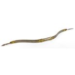 An Eastern steel bow, of shaped form with yellow metal inlay, scroll and floral border, 83cm