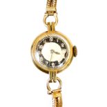 A ladies 9ct gold cocktail watch, with black chaptering, 1.5cm diameter, with Arabic numerals and