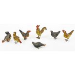 A set of seven unusual early/mid 20thC cockerel and hen ornaments, 8cm high, with metal mounts and