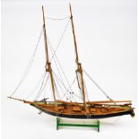 A 20thC wooden model of a warship, with realistic decking set with cannons and masts, on plain