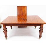 A Victorian mahogany extending wind out dining table, the moulded oblong top raised on heavy