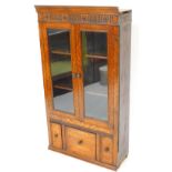 An early 20thC oak bookcase top, with carved rosette section raised above two plain glazed doors and