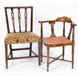 An Edwardian mahogany corner chair, with shaped overstuffed seat on turned legs joined by an X