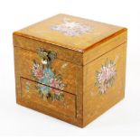 A painted vanity box, decorated with gilt coloured scrolls, the lid heavily decorated with flowers