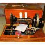 An early 20thC Frister sewing machine in wooden case, 50cm wide.