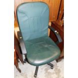 A swivel office chair in green leatherette, 104cm high.