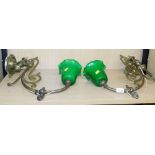 Two hanging lights with shaped brass brackets and green shades, each shade 16cm high.