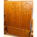 A pine triple door wardrobe with drawers beneath, 120cm wide.