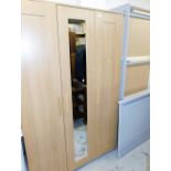 A light beech triple door wardrobe, 118cm wide and a divan style bed.